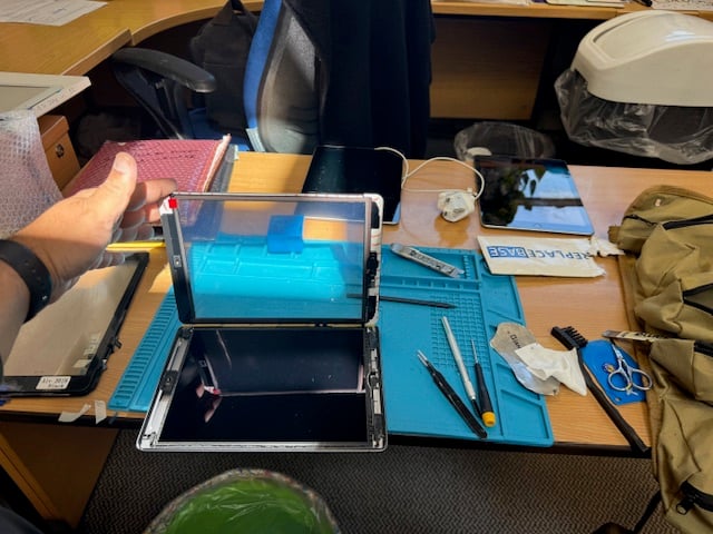 Technician performing iPad repair on-site