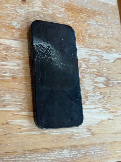 Shattered black screen of an iPhone 16 Pro before repair in Vauxhall SW8.