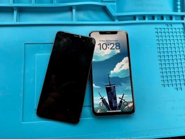 After-repair image showing working iPhone XS Max with the removed broken screen beside it — iRepairMan Slough call-out