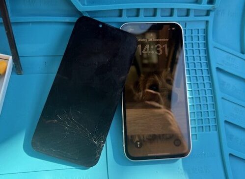 During repair: iPhone internals visible while housing is replaced
