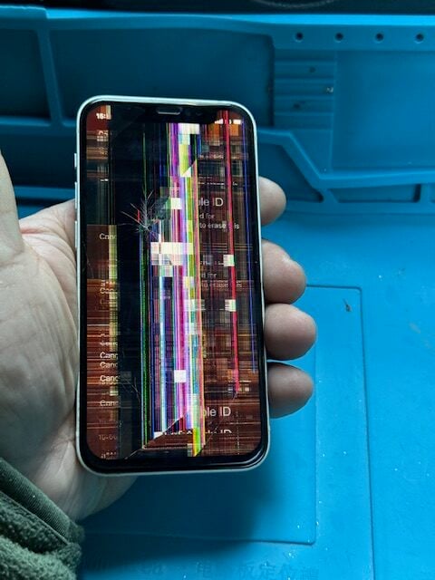 Broken iPhone 12 mini showing colourful lines and LCD damage before repair in Moorgate