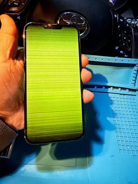 Before: iPhone 13 Pro Max with shattered screen and green LCD tint