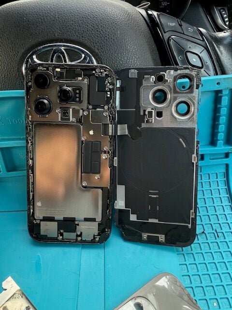 Disassembled iPhone 16 Pro showing internal components during back glass replacement