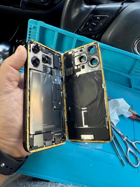 iPhone 16 Pro frame cleaned and fresh double-sided adhesive applied before closing