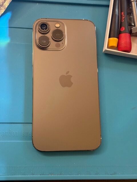Before repair close-up: iPhone 13 Pro Max with missing top-left rear camera glass in Woodford IG8