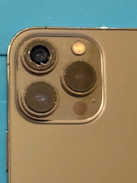 Close-up of the damaged iPhone 13 Pro Max camera area just before adhesive prep
