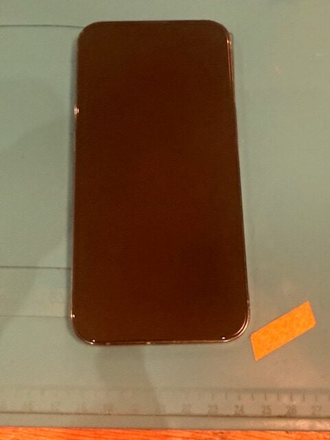 Cracked back glass on iPhone 13 Pro showing water entry point before repair