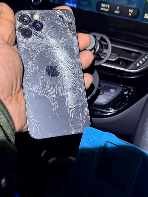 Before repair: iPhone 12 Pro with cracked display near earpiece