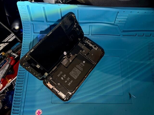 iPhone 12 Pro Max opened during screen replacement showing internal components