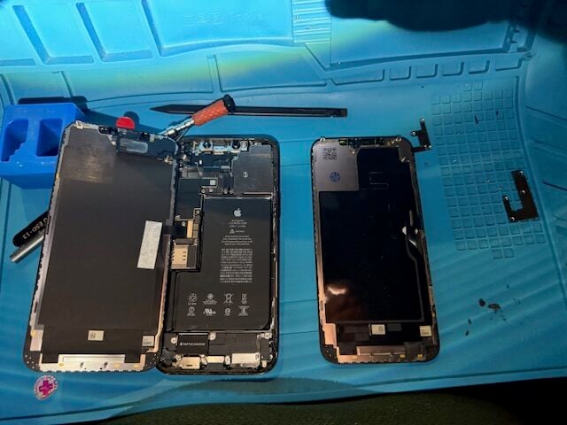 iPhone 12 Pro Max repair process showing final assembly stage