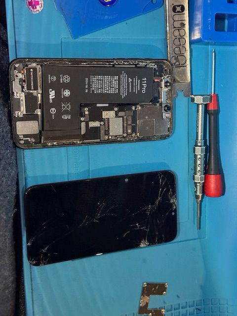 Technician preparing new screen for iPhone