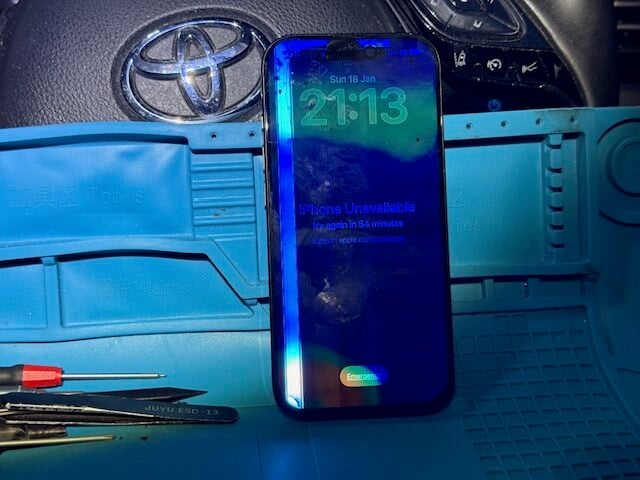 Step 1 iPhone 16 Pro before repair showing screen damage on technician mat inside iRepairMan mobile workstation
