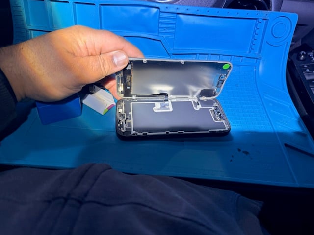 Step 3 technician begins iPhone 16 Pro repair process using professional tools inside mobile setup