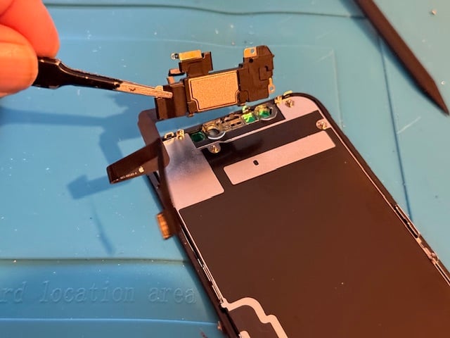 Technician opening iPhone for repair