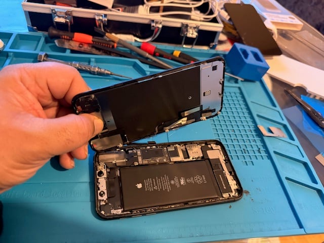 Technician removing iPhone screen