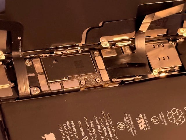Technician installing new iPhone screen