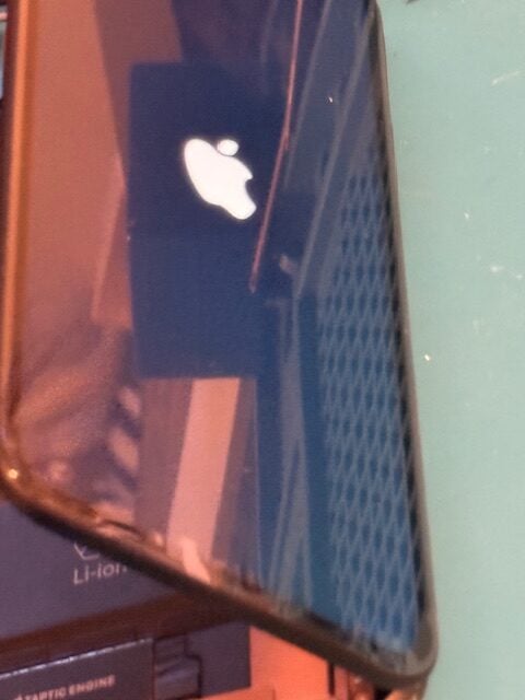 Technician testing iPhone screen after repair