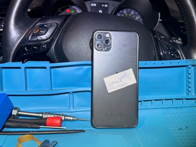 iPhone 11 Pro Max placed on repair mat before emergency night screen repair at hospital