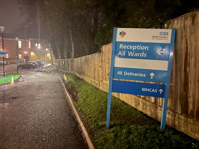 Hospital reception signage at night where emergency iPhone screen repair was carried out