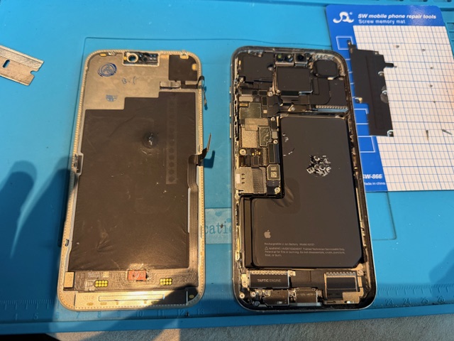 Step 2 broken iPhone 15 Pro Max display removed during screen replacement process