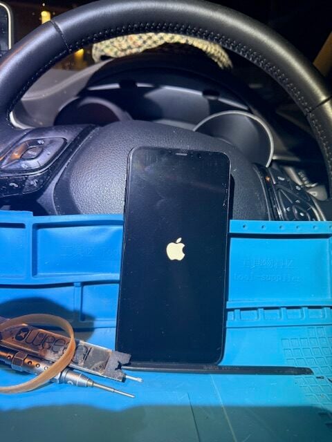 Testing new iPhone screen during emergency night repair at hospital