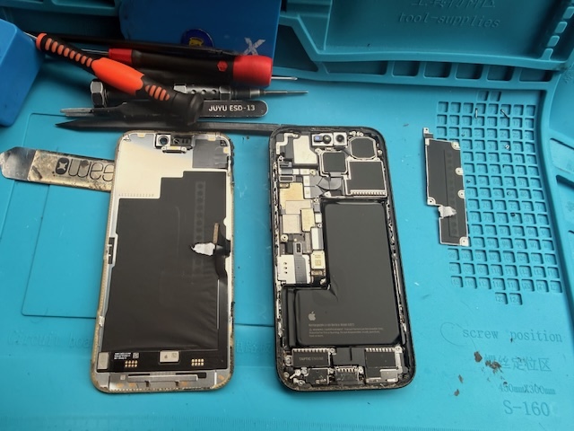 Using nylon spudger to unplug display flex cables during iPhone 15 Pro screen replacement in Paddington Green W2 London