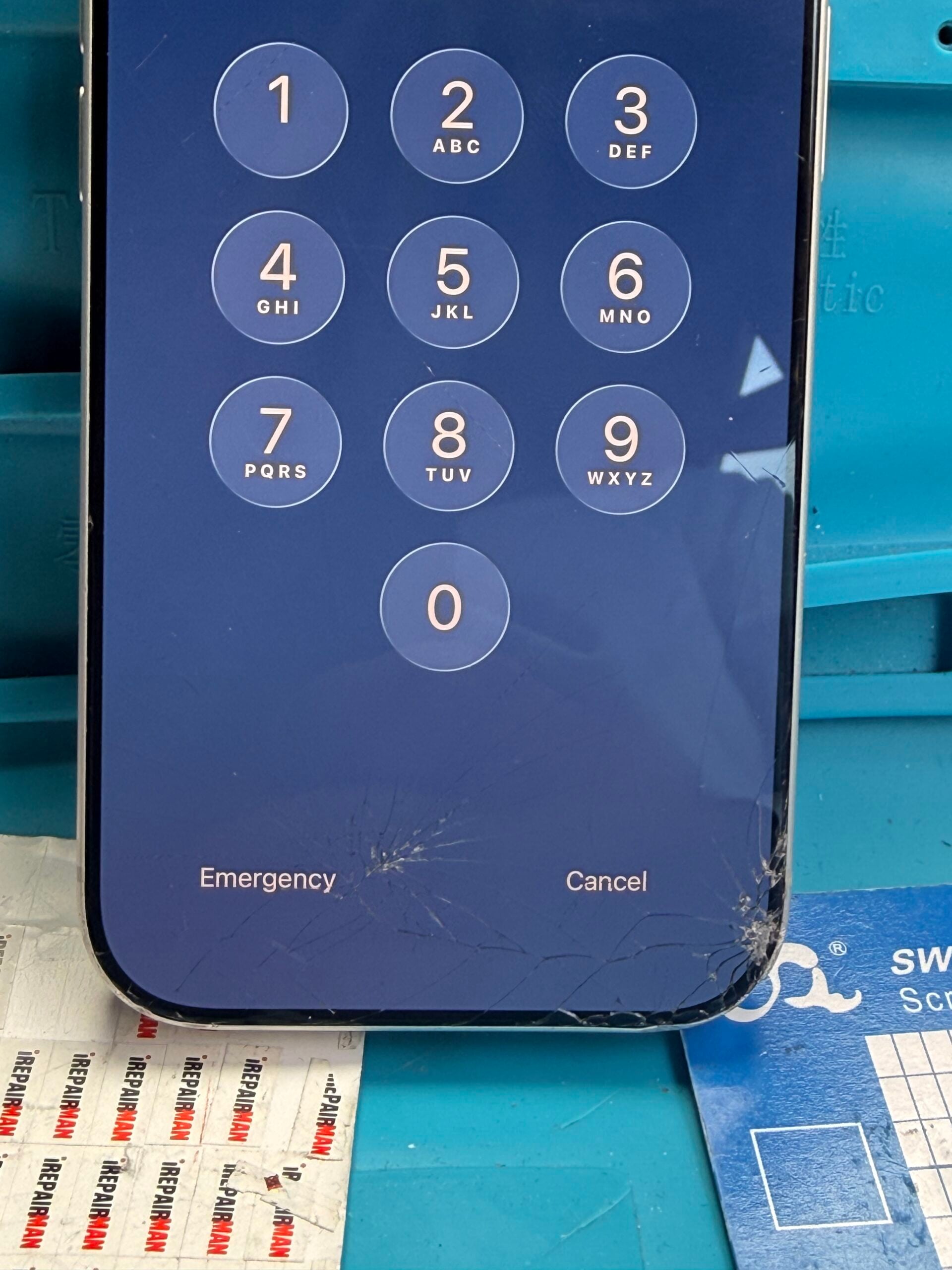 Close-up of cracks across the bottom of an iPhone 17 Pro screen, with concentrated damage at the lower-right corner.